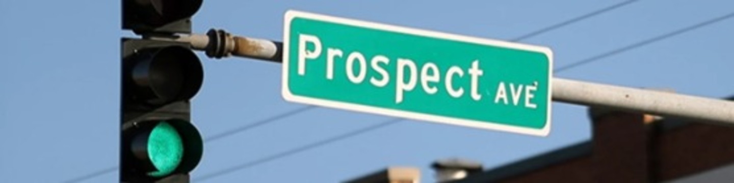 image of the street sign for Prospect Avenue hanging next to a traffic signal